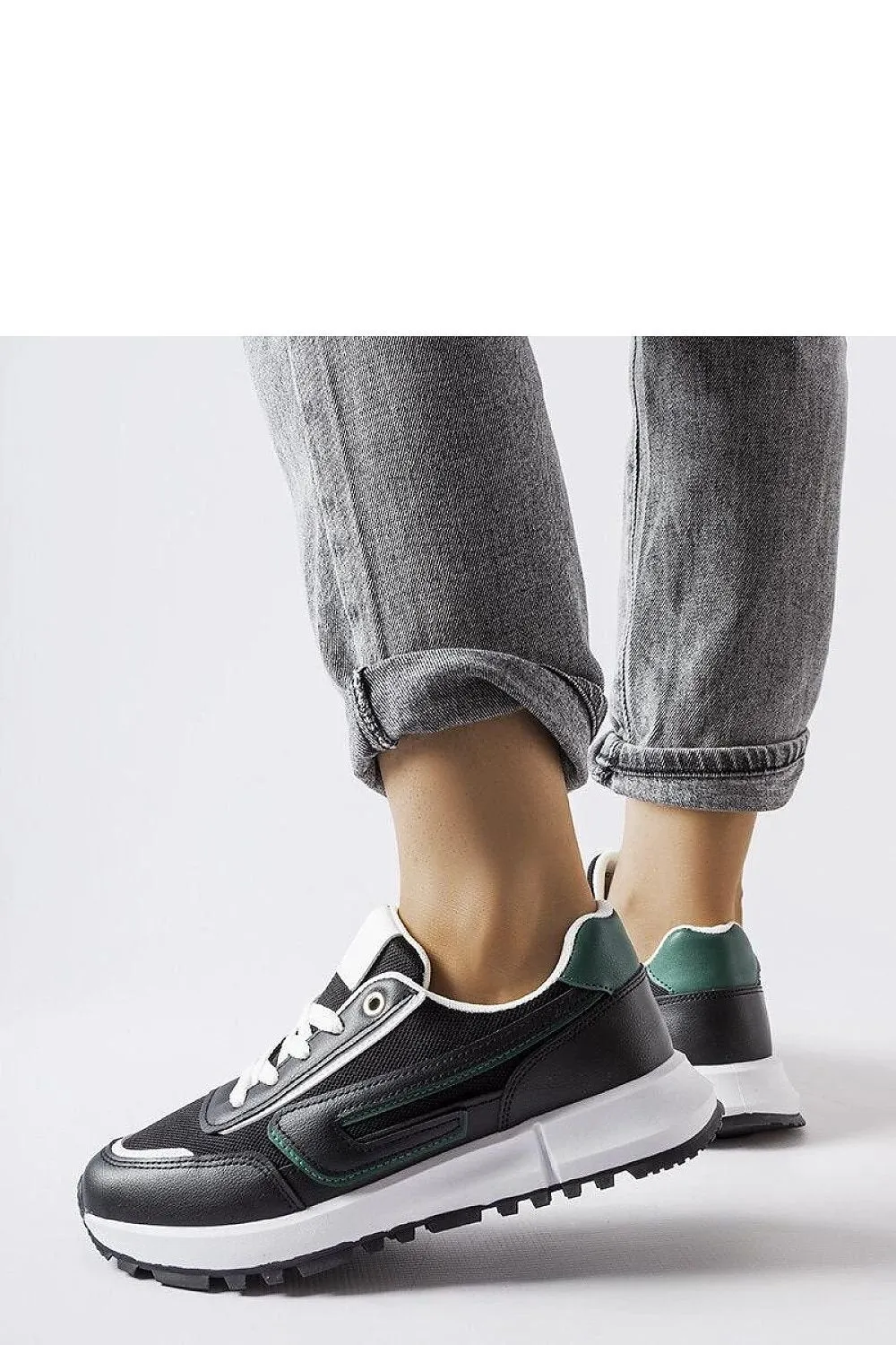 Black sneakers with a green accent