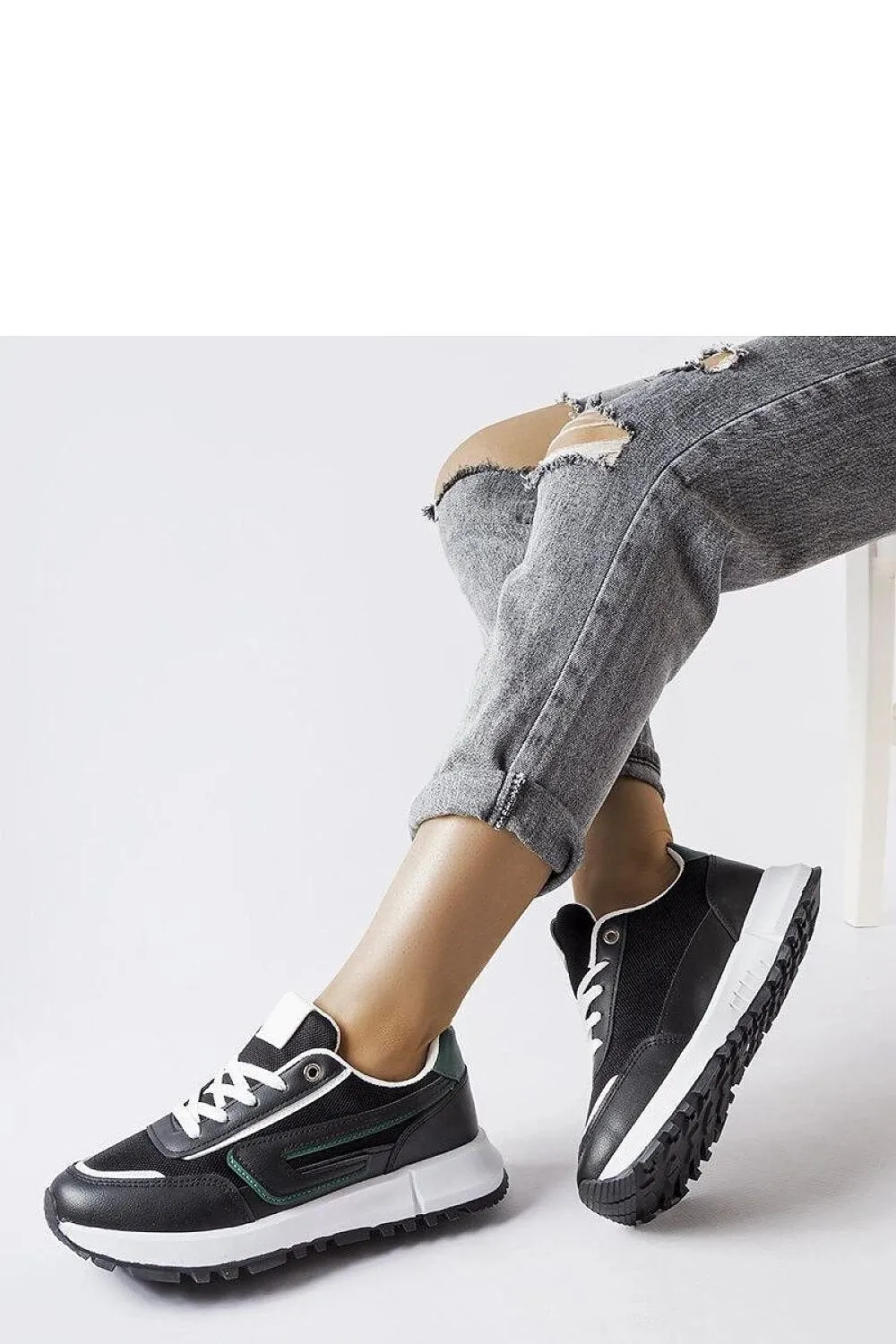 Black sneakers with a green accent